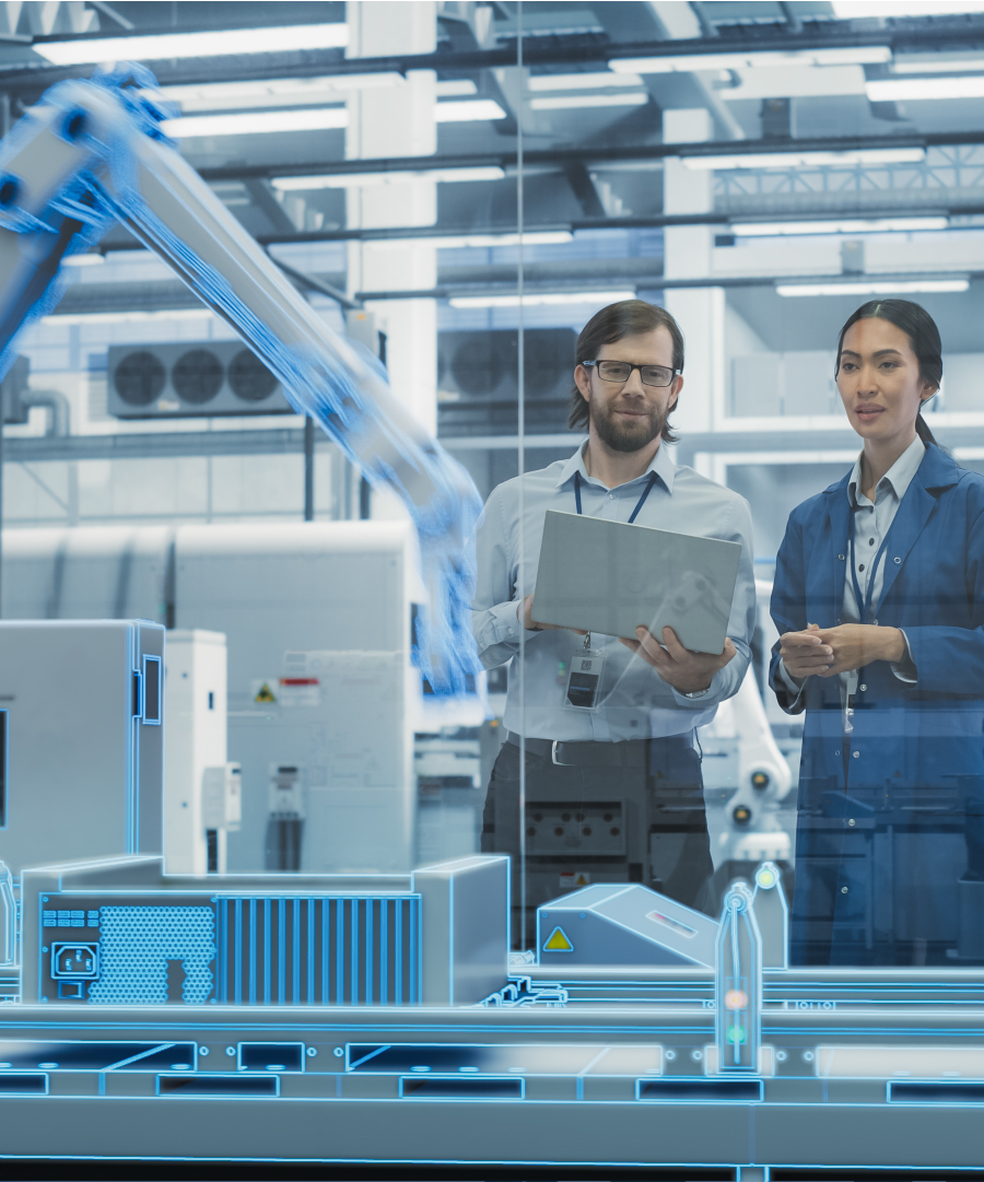 two people in a manufacturing line with robot arms