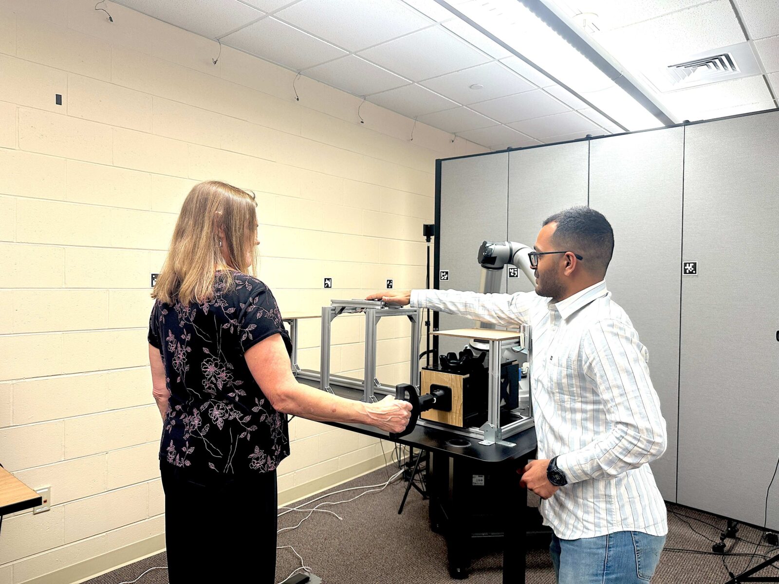 two people interacting with testing equipment