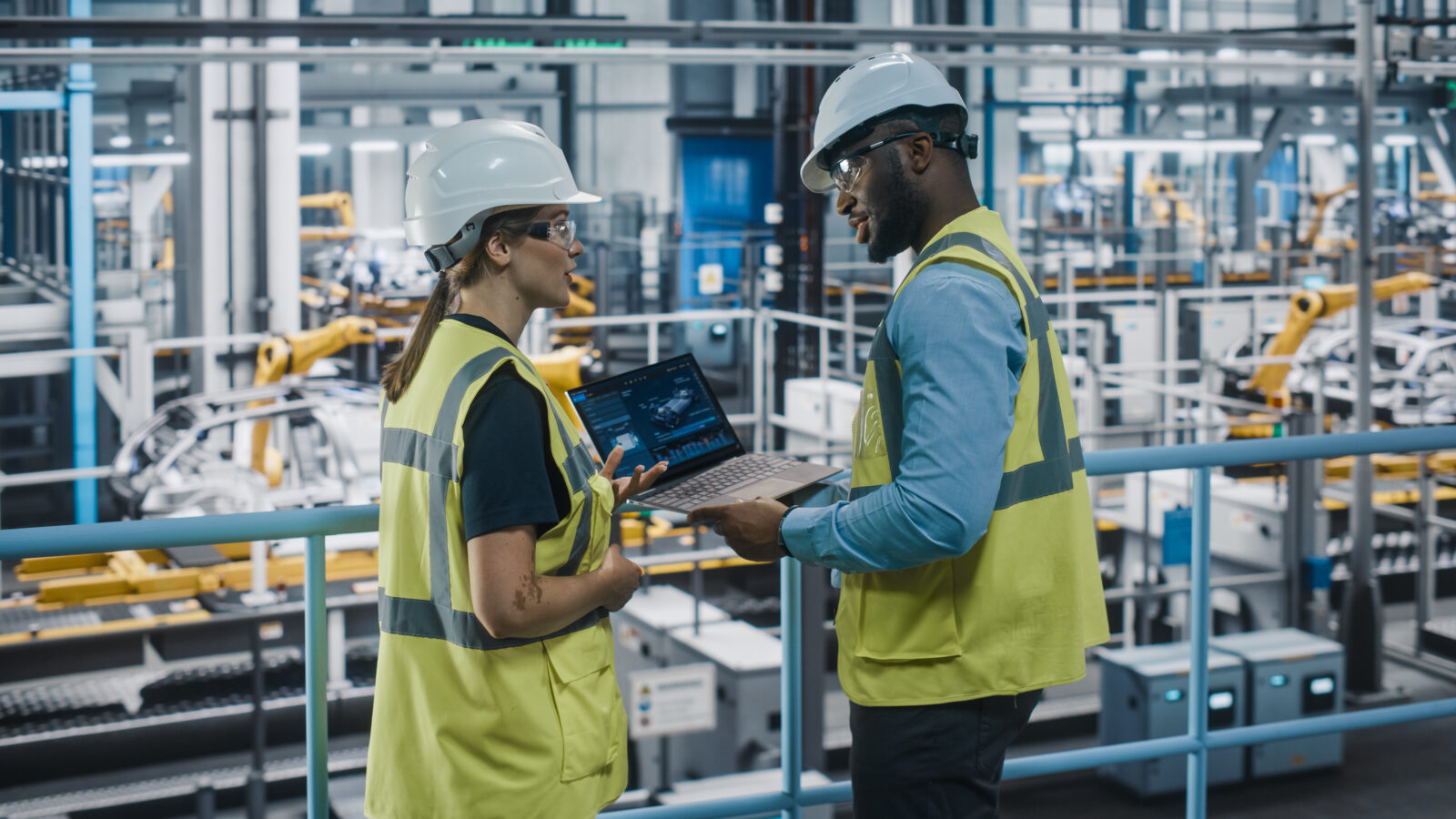 two people in a large manufacturing space