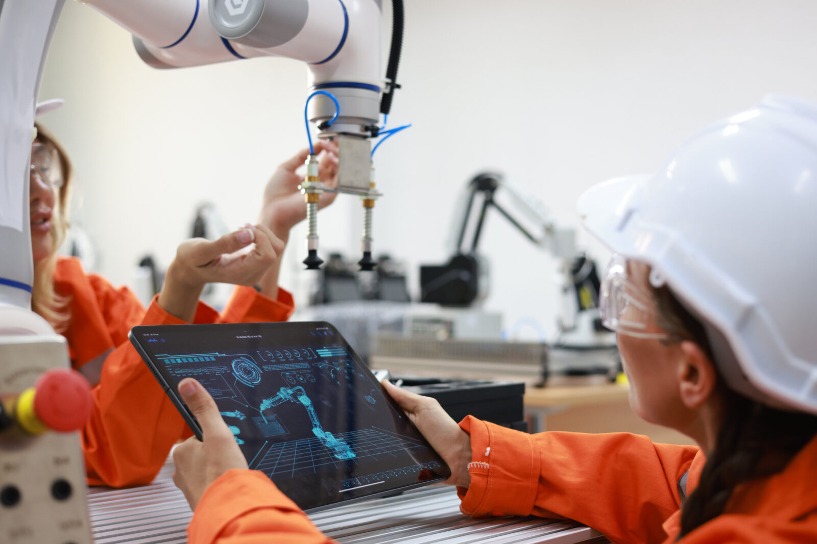 two people working with a robot